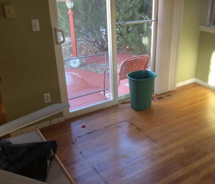 Wood flooring covered in dirt and residue. 