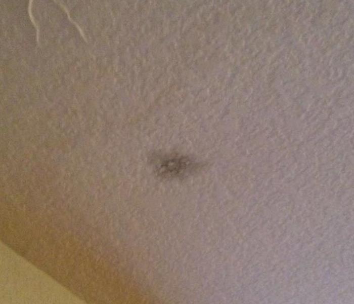 White ceiling with a dark spot. 